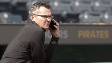 Jun 5, 2024; Pittsburgh, Pennsylvania, USA;  Pittsburgh Pirates general manager Ben Cherington speaks on the phone in the dugout before the Pirates host the Los Angeles Dodgers at PNC Park. Mandatory Credit: Charles LeClaire-Imagn Images