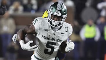 Oct 26, 2024; Ann Arbor, Michigan, USA;  Michigan State Spartans running back Nate Carter (5) rushes against the Michigan Wolverines at Michigan Stadium. Mandatory Credit: Rick Osentoski-Imagn Images