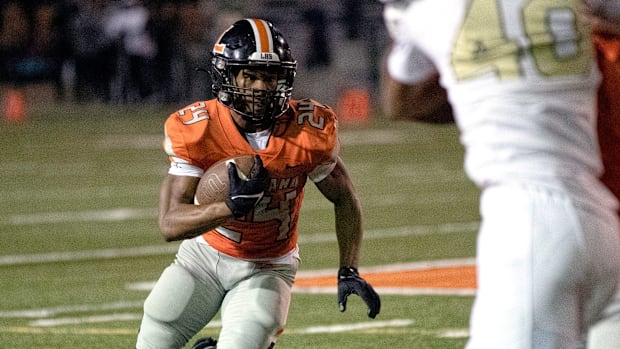 Lakeland's Jadarius Dobie (24) looks for a hole against Mitchell on Friday night at Bryant Stadium.