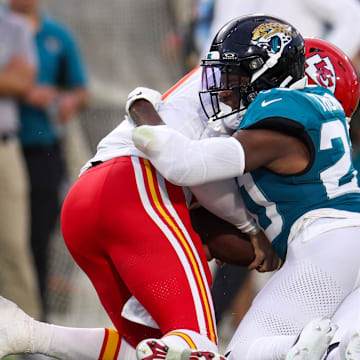 Aug 10, 2024; Jacksonville, Florida, USA; Jacksonville Jaguars safety Daniel Thomas (20) brings down Kansas City Chiefs quarterback Carson Wentz (11) in the second quarter during preseason at EverBank Stadium. Mandatory Credit: Nathan Ray Seebeck-Imagn Images