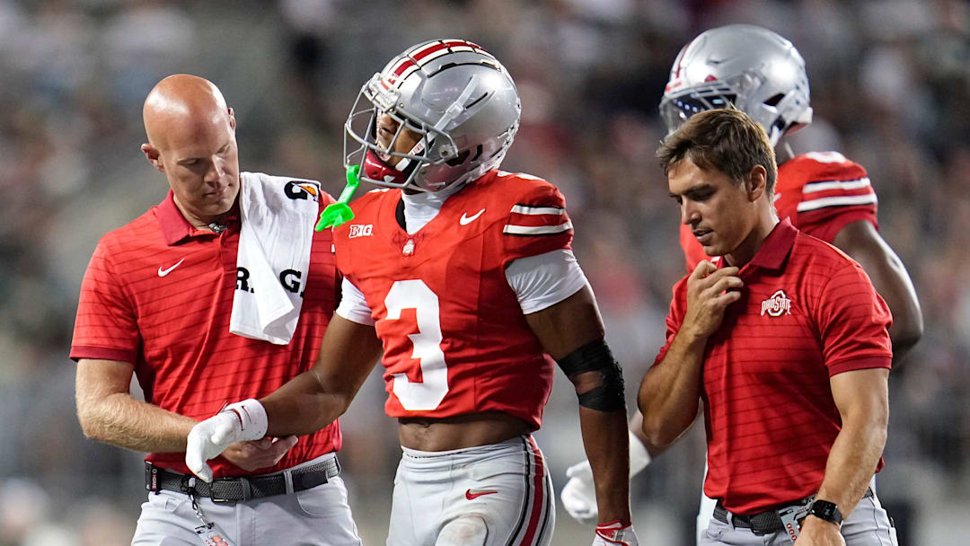Ohio State Buckeyes cornerback Lorenzo Styles Jr. (3) is helped off the field by trainers during the second half of the NCAA football game against the Ohio Bobcats at Ohio Stadium on Sept. 13, 2025. Ohio State won 37-9.