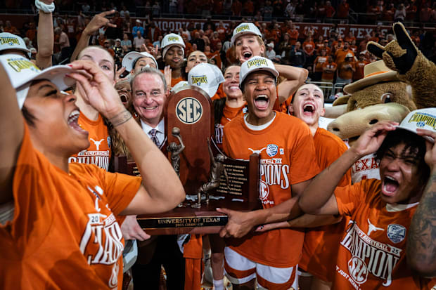 Texas Longhorns celebrate with the SEC championship trophy.