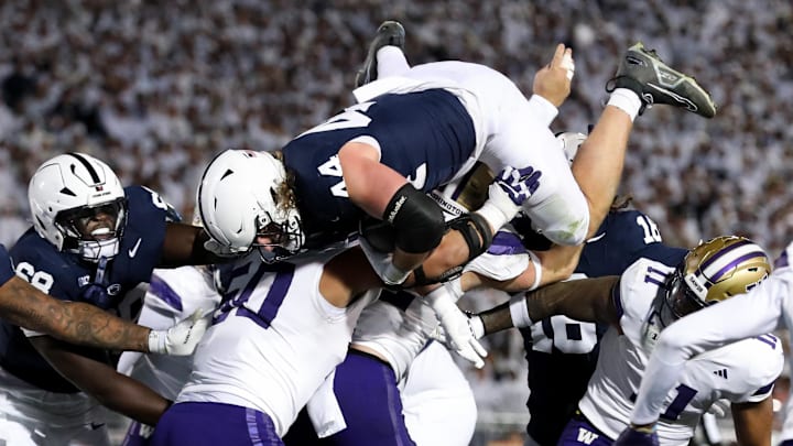 Nov 9, 2024; University Park, Pennsylvania, USA; Penn State Nittany Lions tight end Tyler Warren (44) jumps over top of the Washington Huskies defense and into the end zone for a touchdown during the second quarter at Beaver Stadium. Mandatory Credit: Matthew O'Haren-Imagn Images
