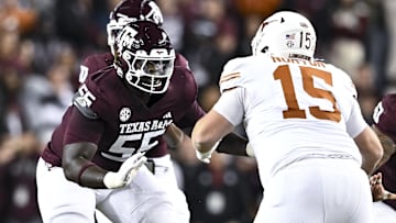 Nov 30, 2024; College Station, Texas, USA; Texas A&M Aggies offensive lineman Ar'maj Reed-Adams (55) blocks against Texas Longhorns defensive lineman Bill Norton (15) during the first quarter. The Longhorns defeated the Aggies 17-7 at Kyle Field. Mandatory Credit: Maria Lysaker-Imagn Images  