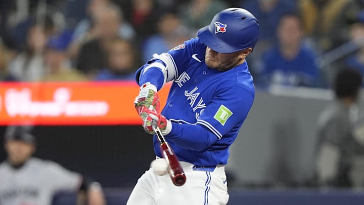 Apr 12, 2026; Toronto, Ontario, CAN; Toronto Blue Jays center fielder Daulton Varsho (5) hits a one run single against the Minnesota Twins during the first inning at Rogers Centre. Mandatory Credit: John E. Sokolowski-Imagn Images