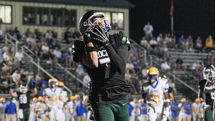 Trinity's Jason Hagan makes the catch over Carmel Greyhounds Isaac Nelson as the Rocks roll 41-14 in the third quarter at Marshall Stadium in Louisville, Kentucky Friday, Sept. 12, 2025.