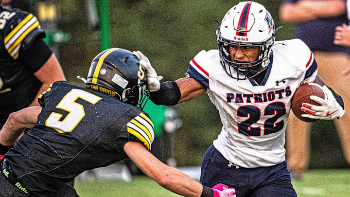 Newark Charter senior Ajay Bonis (22) hangs on to the ball and fends off Tatnall junior Joseph Datilio (5) during the football game at Tatnall in Greenville on Sept. 12, 2025. Newark Charter won 22-21.