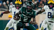 Oct 25, 2025; East Lansing, Michigan, USA; Michigan State Spartans quarterback Aidan Chiles (2) carries the ball against the Michigan Wolverines during the second half at Spartan Stadium.