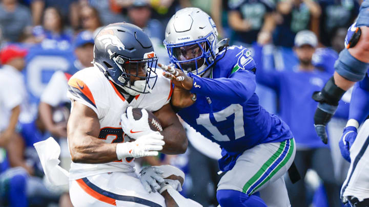 Sep 8, 2024; Seattle, Washington, USA; Seattle Seahawks linebacker Jerome Baker (17) tackles Denver Broncos running back Audric Estime (23) for a loss during the third quarter at Lumen Field. Mandatory Credit: Joe Nicholson-Imagn Images