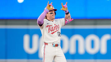 Jul 26, 2025; Minneapolis, Minnesota, USA; Minnesota Twins left fielder Harrison Bader (12) hits a ground rule double in the eighth inning off Washington Nationals pitcher Jackson Rutledge (79) at Target Field. Mandatory Credit: Matt Blewett-Imagn Images
