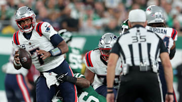 Sep 19, 2024; East Rutherford, New Jersey, USA; New York Jets safety Chuck Clark (36) sacks New England Patriots quarterback Jacoby Brissett (7) during the second quarter at MetLife Stadium. Mandatory Credit: Brad Penner-Imagn Images