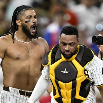 Sep 4, 2024; San Diego, California, USA; San Diego Padres right fielder Fernando Tatis Jr. (23), center, celebrates with Jackson Merrill (3), left, and  Elias Diaz (15) after hitting a walk-off single during the tenth inning against the Detroit Tigers at Petco Park. Mandatory Credit: Denis Poroy-Imagn Images