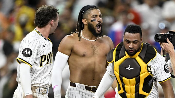 Sep 4, 2024; San Diego, California, USA; San Diego Padres right fielder Fernando Tatis Jr. (23), center, celebrates with Jackson Merrill (3), left, and  Elias Diaz (15) after hitting a walk-off single during the tenth inning against the Detroit Tigers at Petco Park. Mandatory Credit: Denis Poroy-Imagn Images