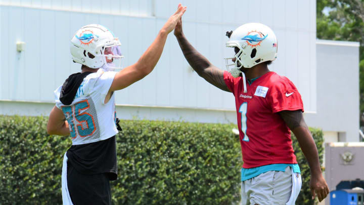 Miami Dolphins teammates River Cracraft (left) and Tua Tagovailoa (right) share a high-five during Tuesday's optional organized team activities on May 28, 2024.