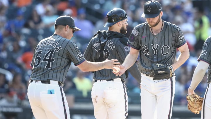 Jul 13, 2024; New York City, New York, USA;  New York Mets starting pitcher Christian Scott (45) is taken out of the game by manager Carlos Mendoza (64) in the fifth inning against the Colorado Rockies at Citi Field. Mandatory Credit: Wendell Cruz-USA TODAY Sports