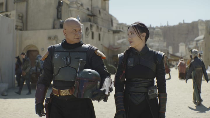 (L-R): Boba Fett (Temuera Morrison) and Fennec Shand (Ming-Na Wen) in Lucasfilm's THE BOOK OF BOBA FETT, exclusively on Disney+. © 2022 Lucasfilm Ltd. & ™. All Rights Reserved.