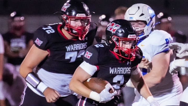 Muskego running back Nick Leto (2) cuts through a gap during the game at home against Mukwonago on Friday, Sept. 13, 2024.