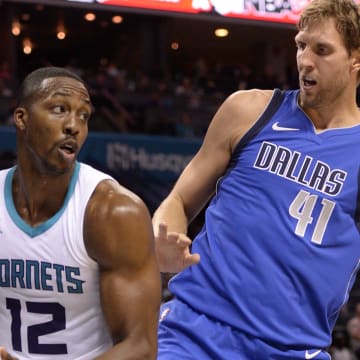 Oct 13, 2017; Charlotte, NC, USA; Charlotte Hornets forward center Dwight Howard (12) gets a rebound against Dallas Mavericks forward Dirk Nowitzki (41) during the second half of the game at the Spectrum Center. Hornets win 111-96. Mandatory Credit: Sam Sharpe-USA TODAY Sports