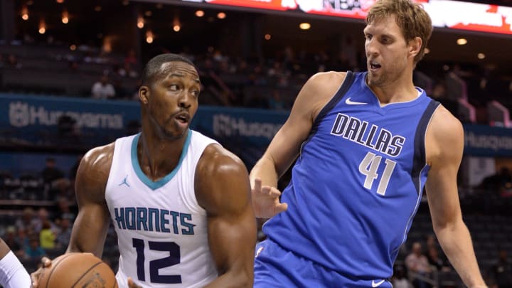 Oct 13, 2017; Charlotte, NC, USA; Charlotte Hornets forward center Dwight Howard (12) gets a rebound against Dallas Mavericks forward Dirk Nowitzki (41) during the second half of the game at the Spectrum Center. Hornets win 111-96. Mandatory Credit: Sam Sharpe-USA TODAY Sports