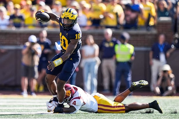 Michigan quarterback Alex Orji runs against USC linebacker Easton Mascarenas-Arnold.