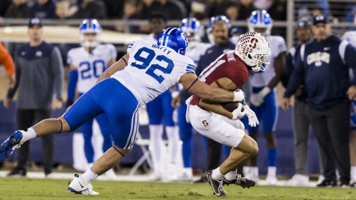 Nov 26, 2022; Stanford, California, USA;  Stanford Cardinal wide receiver Brycen Tremayne (81) is tackled by Brigham Young Cougars defensive lineman Tyler Batty (92) during the first half at Stanford Stadium.