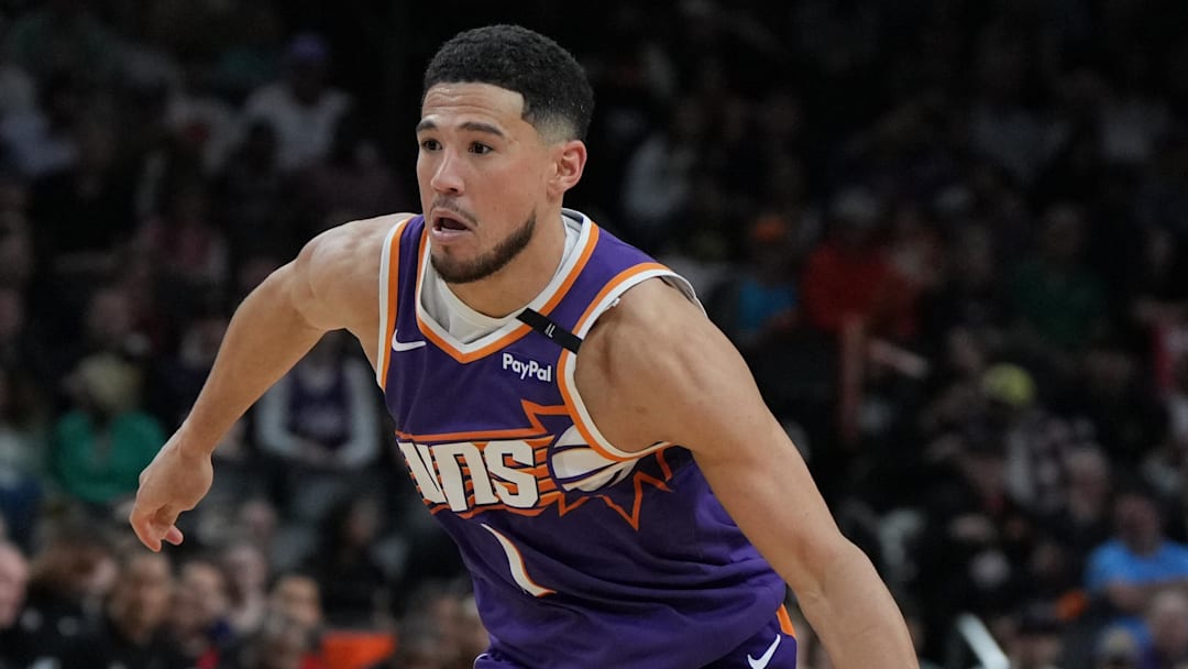 Mar 17, 2025; Phoenix, Arizona, USA; Phoenix Suns guard Devin Booker (1) drives on the Toronto Raptors in the second half at Footprint Center. Mandatory Credit: Rick Scuteri-Imagn Images
