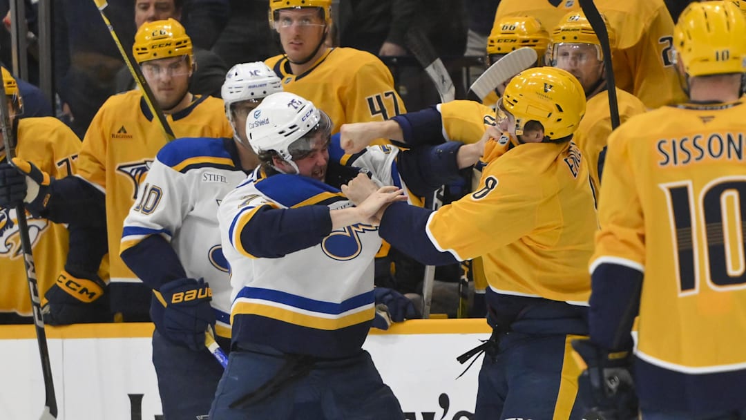 Mar 27, 2025; Nashville, Tennessee, USA;  Nashville Predators defenseman Andreas Englund (8) connects to St. Louis Blues center Zack Bolduc (76) during the second period at Bridgestone Arena. Mandatory Credit: Steve Roberts-Imagn Images
