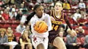 Wisconsin freshman guard Ronnie Porter drives past Minnesota's Isabelle Gradwell at the Kohl Cente