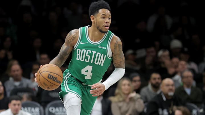 Nov 18, 2025; Brooklyn, New York, USA; Boston Celtics guard Anfernee Simons (4) brings the ball up court against the Brooklyn Nets during the second quarter at Barclays Center. 