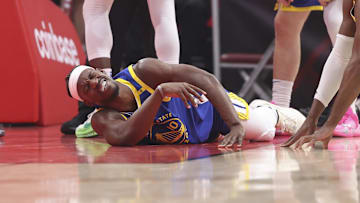 Apr 23, 2025; Houston, Texas, USA; Golden State Warriors forward Jimmy Butler III (10) suffers an apparent injury during the first quarter during game two of the first round for the 2024 NBA Playoffs against the Houston Rockets at Toyota Center. Mandatory Credit: Troy Taormina-Imagn Images