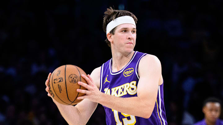 Mar 27, 2026; Los Angeles, California, USA; Los Angeles Lakers guard Austin Reaves (15) looks to pass against Brooklyn Nets guard Ochai Agbaji (30) during the second half at Crypto.com Arena. Mandatory Credit: William Liang-Imagn Images