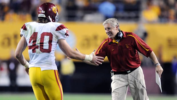 Nov 7, 2009; Tempe, AZ, USA; Southern California Trojans coach Pete Carroll (right) congratulates tight end Rhett Ellison (40