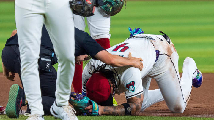 Aug 10, 2024; Phoenix, Arizona, USA; Arizona Diamondbacks infielder Ketel Marte (4) reacts after a collision with Philadelphia Phillies catcher Garrett Stubbs (21) (not shown) at second base in the fourth inning during a game against the Philadelphia Phillies at Chase Field. Mandatory Credit: Allan Henry-USA TODAY Sports  