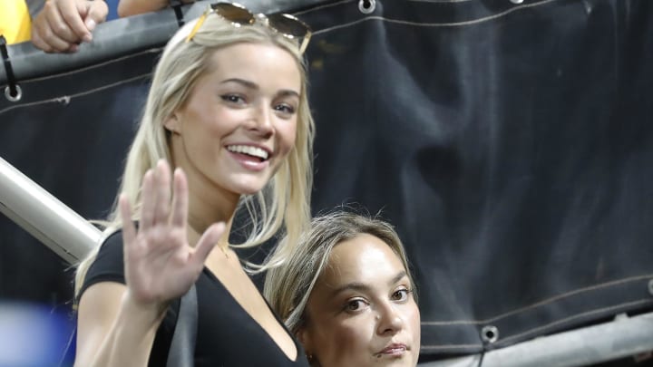 Jul 23, 2024; Pittsburgh, Pennsylvania, USA;  Louisiana State University gymnast Olivia Dunne (left) waves as she exits the field after watching the Pittsburgh Pirates host the St. Louis Cardinals at PNC Park. St. Louis won 2-1.