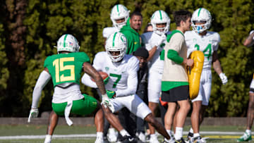 Oregon wide receiver Evan Stewart attempts to avoid defensive back Solomon Davis during practice with the Oregon Ducks Tuesday, April 9, 2024, at the Hatfield-Dowlin Complex in Eugene, Ore.