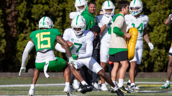 Oregon wide receiver Evan Stewart attempts to avoid defensive back Solomon Davis during practice with the Oregon Ducks Tuesday, April 9, 2024, at the Hatfield-Dowlin Complex in Eugene, Ore.