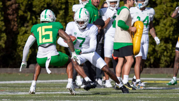 Oregon wide receiver Evan Stewart attempts to avoid defensive back Solomon Davis during practice with the Oregon Ducks Tuesday, April 9, 2024, at the Hatfield-Dowlin Complex in Eugene, Ore.