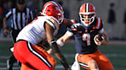 Nov 15, 2025; Champaign, Illinois, USA; Illinois Fighting Illini quarterback Luke Altmyer (9) runs with the football during the first half against the Maryland Terrapins at Memorial Stadium. Mandatory Credit: Ron Johnson-Imagn Images