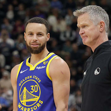 Feb 15, 2024; Salt Lake City, Utah, USA; Golden State Warriors guard Stephen Curry (30) and head coach Steve Kerr talk on the sideline during the first quarter against the Utah Jazz at Delta Center. Mandatory Credit: Chris Nicoll-Imagn Images