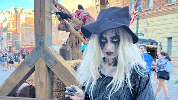 A scareactor stares down guests in the Torture Faire scare zone at Universal Orlando's Halloween Horror Nights.
