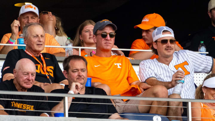 Jun 24, 2024; Omaha, NE, USA; Tennessee Volunteers men’s basketball coach Rick Barnes, Peyton Manning and Morgan Wallen watch the game against the Texas A&M Aggies during the fourth inning at Charles Schwab Field Omaha. Mandatory Credit: Dylan Widger-USA TODAY Sports