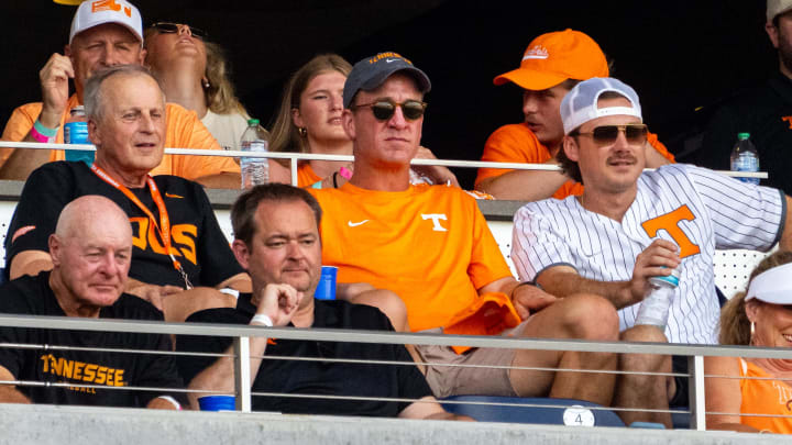 Jun 24, 2024; Omaha, NE, USA; Tennessee Volunteers men’s basketball coach Rick Barnes, Peyton Manning and Morgan Wallen watch the game against the Texas A&M Aggies during the fourth inning at Charles Schwab Field Omaha. Mandatory Credit: Dylan Widger-USA TODAY Sports