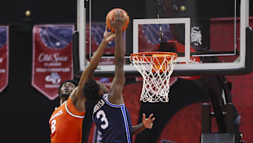 Nov 27, 2025; Kissimmee, Florida, USA; Miami (FL) Hurricanes center Ernest Udeh Jr. (8) blocks a shot from Brigham Young University Cougars forward AJ Dybantsa (3) in the first half at State Farm Field House. Mandatory Credit: Nathan Ray Seebeck-Imagn Images