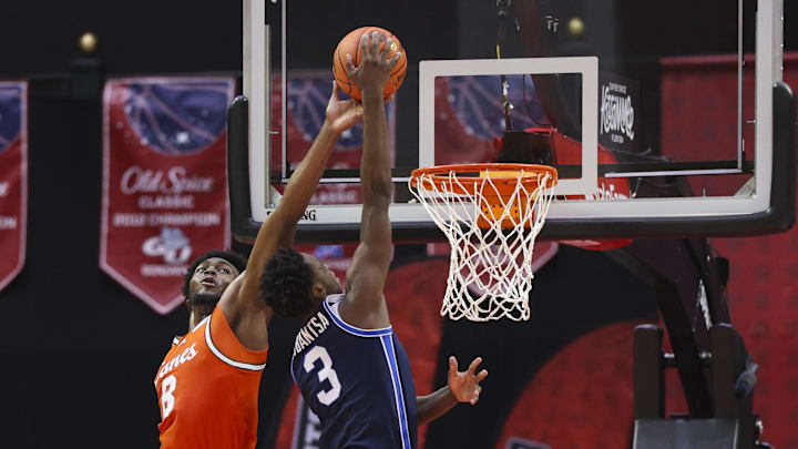 Nov 27, 2025; Kissimmee, Florida, USA; Miami (FL) Hurricanes center Ernest Udeh Jr. (8) blocks a shot from Brigham Young University Cougars forward AJ Dybantsa (3) in the first half at State Farm Field House. Mandatory Credit: Nathan Ray Seebeck-Imagn Images