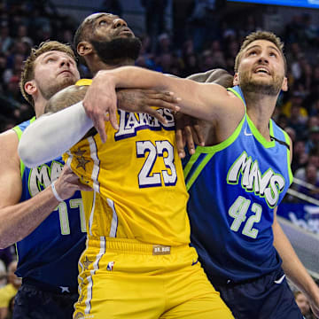 Jan 10, 2020; Dallas, Texas, USA; Dallas Mavericks forward Luka Doncic (77) and forward Maxi Kleber (42) defend against Los Angeles Lakers forward LeBron James (23) during the second half at the American Airlines Center. Mandatory Credit: Jerome Miron-Imagn Images