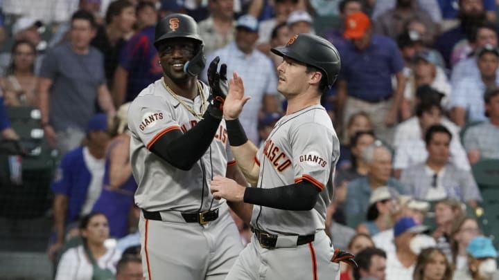 Jun 18, 2024; Chicago, Illinois, USA; San Francisco Giants outfielder Mike Yastrzemski (right) is greeted by designated hitter Jorge Soler (left) after scoring against the Chicago Cubs during the fifth inning at Wrigley Field. Mandatory Credit: David Banks-USA TODAY Sports