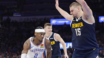 Mar 10, 2025; Oklahoma City, Oklahoma, USA; Oklahoma City Thunder guard Shai Gilgeous-Alexander (2) drives against Denver Nuggets center Nikola Jokic (15) during the second half at Paycom Center. Mandatory Credit: Alonzo Adams-Imagn Images