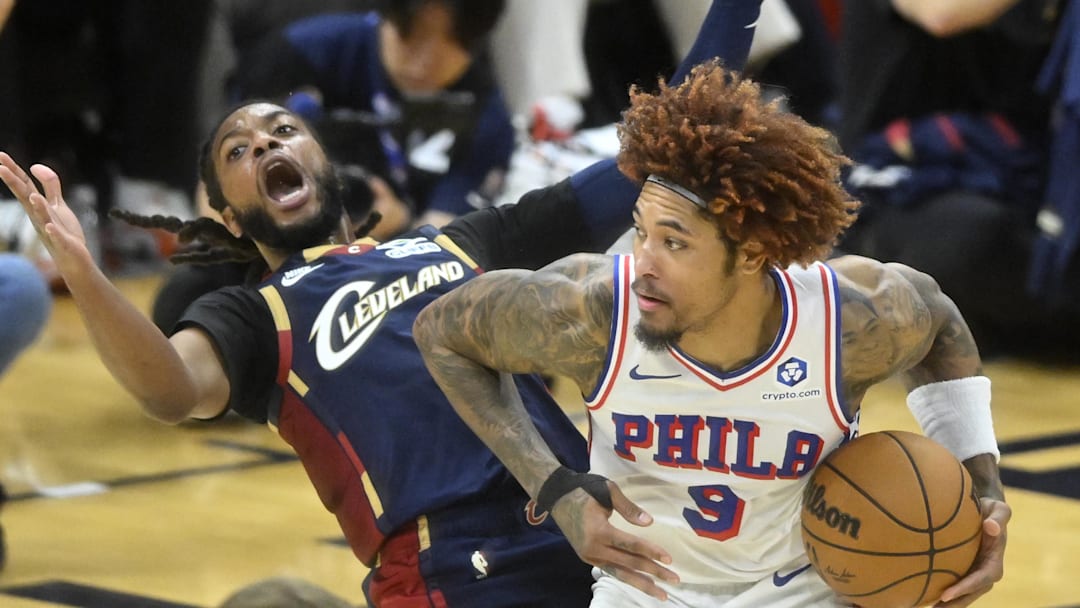 Nov 5, 2025; Cleveland, Ohio, USA; Philadelphia 76ers guard Kelly Oubre Jr. (9) backs in to Cleveland Cavaliers guard Darius Garland (10) in the fourth quarter at Rocket Arena. Mandatory Credit: David Richard-Imagn Images