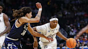 March 20, 2025; Denver, CO, USA; Texas A&M Aggies guard Zhuric Phelps (1) drives against Yale Bulldogs forward Casey Simmons (14) during the first half at Ball Arena. Mandatory Credit: Isaiah J. Downing-Imagn Images