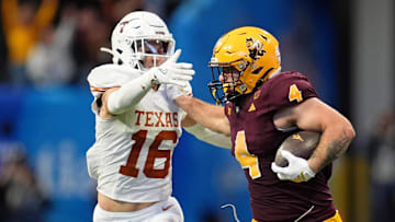 Arizona State Sun Devils running back Cam Skattebo (4) pushes Texas Longhorns defensive back Michael Taaffe (16) away during the second half of the Peach Bowl at Mercedes-Benz Stadium. 